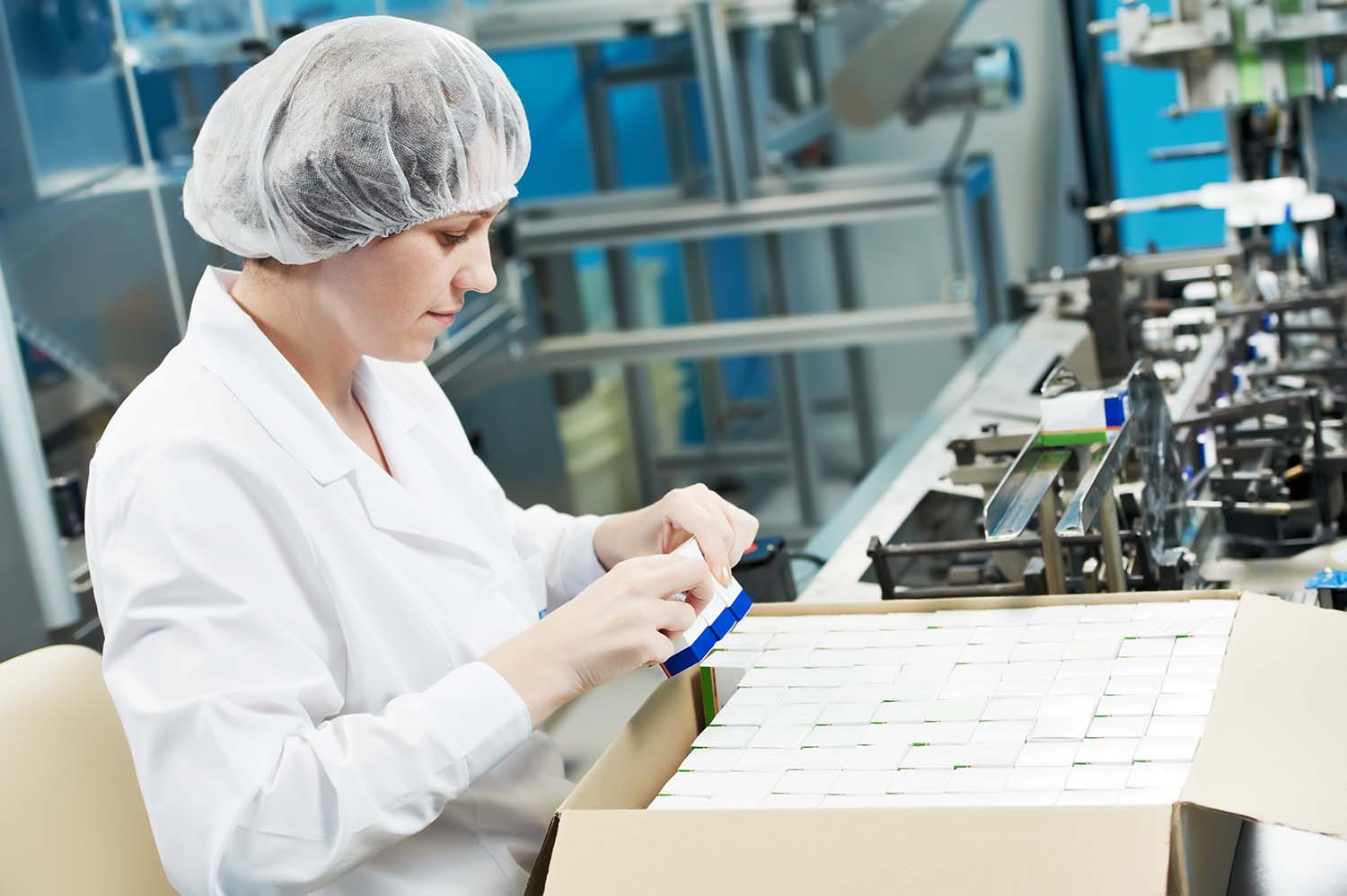 Worker packing eliquid at manufacturing facility.